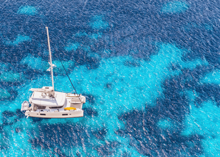Catamaran on anchor blue sea